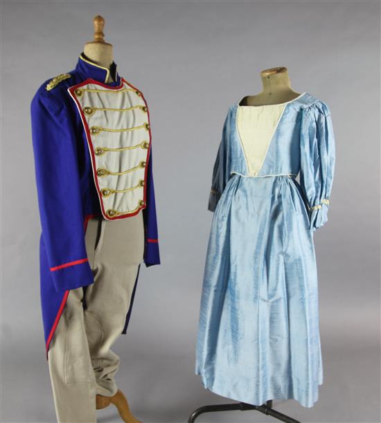 LElisir dAmore: A rail of Royal blue tail coats with red and gold trim, a quantity of peasant blouses and skirts,